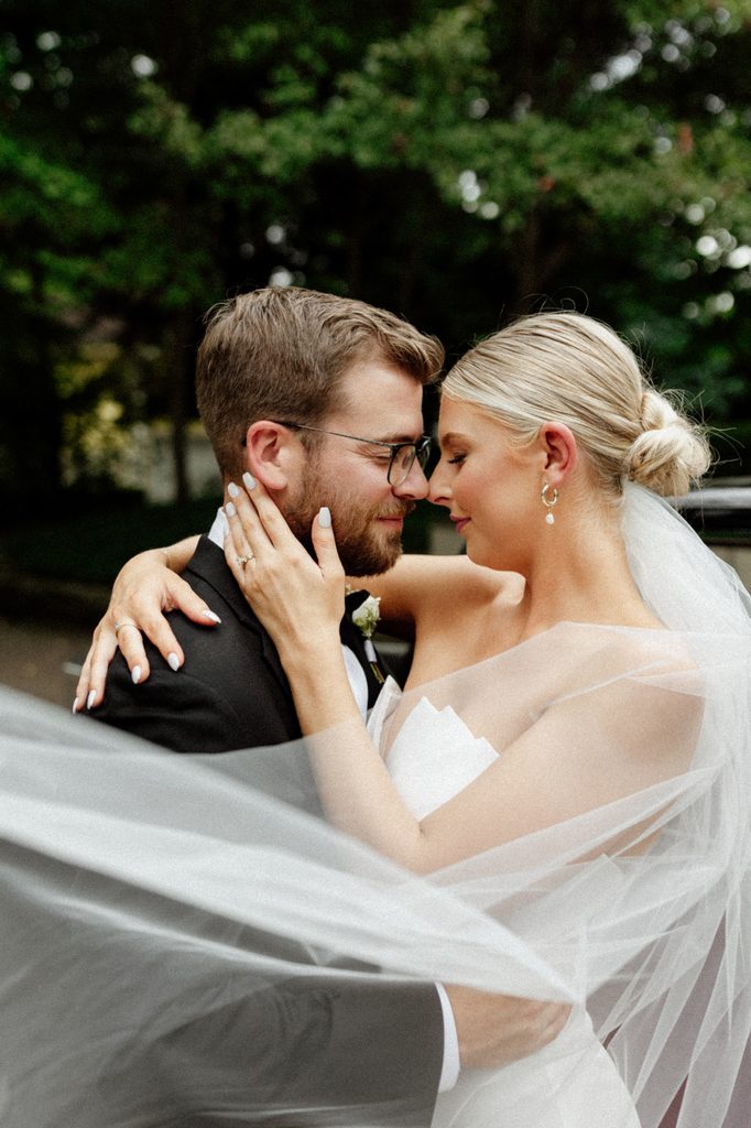 Bride and groom sharing a kiss along a brick-lined street in downtown Indianapolis.