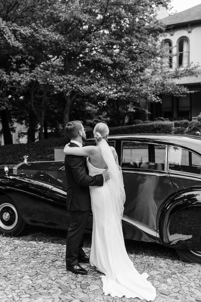 Bride and groom embracing along a tree-lined street in Lockerbie Square, Indianapolis.