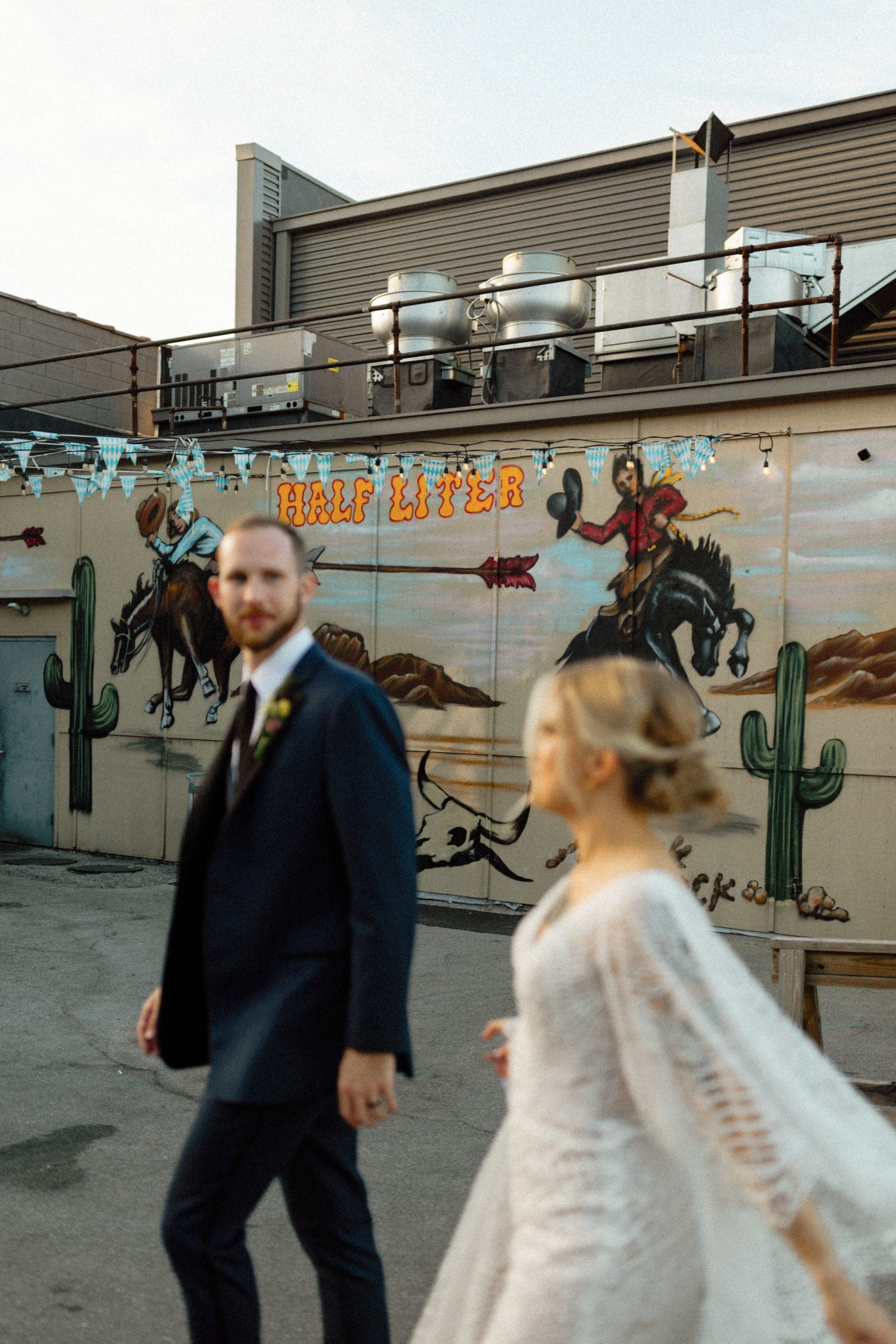 Kimmy and Ben celebrating their colorful Liter House wedding in Indianapolis, Indiana, surrounded by friends and family.
